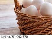 Basket with white eggs. White eggs in a wicker basket. Simple composition. Стоковое фото, фотограф Анастасия  Гудантова / Фотобанк Лори