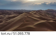 Aerial view of sand dunes in desert at sunset. Стоковое фото, фотограф Михаил Коханчиков / Фотобанк Лори