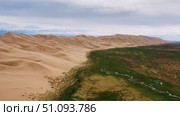 Sand dunes under cloudy sky in Gobi Desert. Стоковое фото, фотограф Михаил Коханчиков / Фотобанк Лори