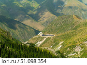 Ala-Archa, Mountain camp set in remote alpine valley, surrounded by steep slopes, green ridges, and pine forests, serving as a base for trekking, climbing, hiking, and outdoor adventure activities. Стоковое фото, фотограф Андрей Ка / Фотобанк Лори