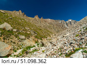 Ala-Archa Mountain landscape featuring rocky terrain, steep slopes, alpine meadows and distant jagged summits ideal for trekking, mountaineering, backcountry hiking, adventure expeditions. Стоковое фото, фотограф Андрей Ка / Фотобанк Лори