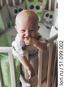 Little One's Grin Lights up Early Morning in the Nursery. Стоковое фото, фотограф Aleksandr Golubev / Фотобанк Лори