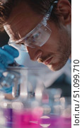 Scientist conducts experiments with colorful liquids in laboratory setting during daylight hours. Стоковое AI-видео, аниматор Сергей Толмачёв / Фотобанк Лори