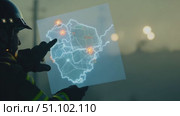 A firefighter examines a digital map, focusing on critical areas during a wildfire incident in California. Стоковое AI-видео, аниматор Данила Большаков / Фотобанк Лори