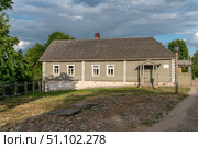 Izborsk, Pechersk district, Pskov region, Russia, 06.10.2024: View of the historical merchant building of the estate on the main street of Izborsk- Pecherskaya - on a sunny summer day. Редакционное фото, фотограф Ula Ulachka / Фотобанк Лори