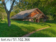 View of an old farm building on the territory of the Mikhailovskoye estate of the Pushkin State Museum-Reserve on a sunny summer day, Pushkinskiye Gory, Pskov region, Russia. Стоковое фото, фотограф Ula Ulachka / Фотобанк Лори