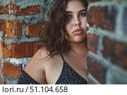 Plus size model posing near brick wall showing body positivity and self acceptance. Стоковое AI-изображение, AI-художник Иван Рябоконь / Фотобанк Лори