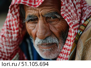 Portrait of bedouin senior man wearing traditional keffiyeh looking at camera. Стоковое AI-изображение, AI-художник Иван Рябоконь / Фотобанк Лори