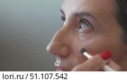 Makeup, Woman, Eye: Brush applies eyeshadow inside, preparing for an indoor, daytime cosmetic enhancement. Стоковое видео, видеограф svetograph / Фотобанк Лори