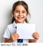 A cute smiling girl in a school uniform is holding a blank sheet of paper. White background. Стоковое AI-изображение, AI-художник Ирина Гильмуллина / Фотобанк Лори