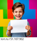 Cute happy boy with smile on face on colorful background. Holding white sheet of paper. Стоковое AI-изображение, AI-художник Ирина Гильмуллина / Фотобанк Лори