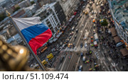 Российский флаг над улицей европейского города. The Russian flag over the street of the European city. Стоковое AI-изображение, AI-художник Смирнова Светлана / Фотобанк Лори