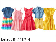 Colorful collection of baby dresses, isolated on a white background. Different styles and colors clothes for baby girls. Rainbow ruffle skirt, denim shirt top, party gown, cotton short-sleeve dresses. Стоковое AI-изображение, AI-художник Марина Демидюк / Фотобанк Лори