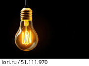 Glowing Yellow Light Bulb. Illuminated Light bulb on dark black background banner. Creative Technology. Vintage Edison Bulbs. Warm Illumination in a night space. New idea, brainstorming concept. Стоковое AI-изображение, AI-художник Марина Демидюк / Фотобанк Лори