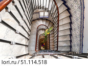 Spiral staircase. Top view. Chandelier and ceramic tiles on the wall. Стоковое фото, фотограф Евгений Ткачёв / Фотобанк Лори