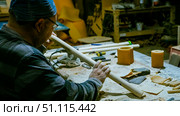 carpenter using nail gun or brad nailer tool on wood box in a workshop ,furniture restoration woodworking concept. selective focus. Стоковое фото, фотограф Feruza Tashmetova / Фотобанк Лори