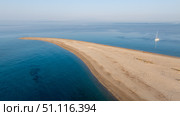 Stunning Possidi cape sandbar in Kassandra, Greece, with sailing boat. Стоковое фото, фотограф Данил Руденко / Фотобанк Лори