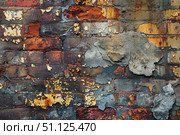Old damaged brick wall with crumbling plaster and peeling paint showing signs of age and decay. Стоковое AI-изображение, AI-художник Иван Рябоконь / Фотобанк Лори