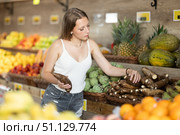 Young woman shopping in vegetable store and buy cassava. Стоковое фото, фотограф Яков Филимонов / Фотобанк Лори