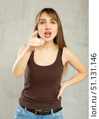 Indignant young woman gesturing in studio. Стоковое фото, фотограф Яков Филимонов / Фотобанк Лори