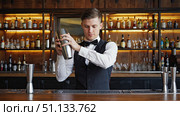 A Skilled Bartender Mixing Cocktails Behind a Stylish Bar with a Variety of Liquors and Glassware in a Cozy Atmosphere. Стоковое AI-изображение, AI-художник Владимир Федоров / Фотобанк Лори