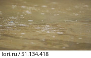 Close-up of a concrete surface soaked with rain, with droplets falling on it. Slow motion of raindrops. Стоковое видео, видеограф Воловодов Владимир / Фотобанк Лори