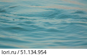 A close-up of the serene surface of the water, showing gentle ripples and bubbles. The soft blue tones evoke thoughts of serenity and tranquility. Стоковое видео, видеограф Воловодов Владимир / Фотобанк Лори