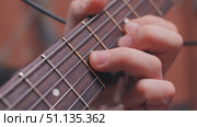 Close-up of a man's hand pressing the strings of an electric guitar, showing the intricate finger placement and beautiful wood grain of the guitar's fingerboard. Стоковое видео, видеограф Воловодов Владимир / Фотобанк Лори