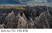 Unique karst rocks. Gray rough furrowed slopes. Sharp spiky peaks. Close-up. Blue sky, clouds. Madagascar. Tsingy De Bemaraha. Стоковое фото, фотограф Вера Ивановна Кубарева / Фотобанк Лори