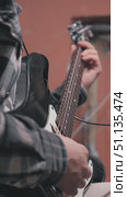 A close-up of a man playing an electric guitar shows his hands holding the fingerboard and playing the strings. Recording a guitar in a home studio. Стоковое видео, видеограф Воловодов Владимир / Фотобанк Лори