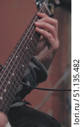 A close-up of a guitarist's hand clutching the strings of an electric guitar against a soft blurred background. The essence of musical passion is conveyed. Work in a recording studio. Стоковое видео, видеограф Воловодов Владимир / Фотобанк Лори