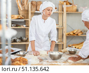 Two women bakers kneading dough in workshop. Стоковое фото, фотограф Яков Филимонов / Фотобанк Лори