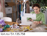 Female seamstress working on sewing machine in workshop. Стоковое фото, фотограф Яков Филимонов / Фотобанк Лори