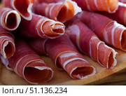 Spanish dry cured jamon on wooden plate. Стоковое фото, фотограф Яков Филимонов / Фотобанк Лори