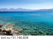 Agios Nikolaos coastline on a sunny day with clear sea and cliffs. (2019 год). Стоковое фото, фотограф Емельянов Евгений Викторович / Фотобанк Лори
