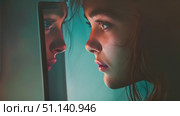 A girl gazes thoughtfully at her reflection in a mirror, lost in deep contemplation. Стоковое AI-видео, аниматор Данила Большаков / Фотобанк Лори