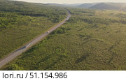 Exploring a scenic highway surrounded by lush greenery and mountains. Стоковое видео, видеограф Гурьянов Андрей / Фотобанк Лори