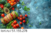Top view lunch box with sandwiches, fruits and vegetables, water bottle on pastel blue isolated background, with copy-space available for text or promotional content. Стоковое AI-изображение, AI-художник Ирина Михайличенко / Фотобанк Лори