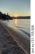 Vertical video of Baikal Lake on summer sunset. View of pebble beach of Olkhon Island on quiet August evening. Picturesque seascape. Natural background. Summer travel. Стоковое видео, видеограф Виктория Катьянова / Фотобанк Лори