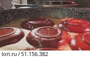 Large pilaf cauldron with steaming rice, covered with cloth and plates. Стоковое видео, видеограф Aleksey Kidisyuk / Фотобанк Лори