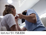 Woman Enjoying a Beauty Transformation With a Skilled Make-Up Artist in a Salon Setting. Стоковое фото, фотограф Aleksandr Golubev / Фотобанк Лори