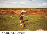 Boy child running, dog and puppy chasing across corn field. Boy loves freedom, child loves sun and sky. Dog running quickly, puppy running near. Field wide, dirt dry, sky endless, freedom alive. Стоковое фото, фотограф Юлия Киселёва / Фотобанк Лори