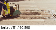 Worker with Asphalt Road Cutting Machine cuts asphalt , banner. Стоковое фото, фотограф Андрей Митин / Фотобанк Лори