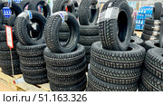 Vladimir, Russia, July 24, 2025: Winter tires at Auchan hypermarket. Редакционное фото, фотограф Igor Skripachev / Фотобанк Лори