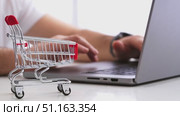 A man makes online purchases through a laptop on marketplaces. Стоковое видео, видеограф Igor Skripachev / Фотобанк Лори