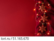 Christmas background with Christmas toys, beads and a garland on a knitted fabric. Стоковое фото, фотограф Aleksandra Selivanova / Фотобанк Лори