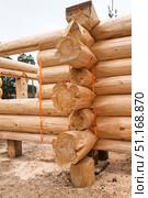 The construction site of a wooden house. Traditional log cabin built from wood logs on sunny summer day. Cottage house design. Стоковое фото, фотограф Светлана Акифьева / Фотобанк Лори