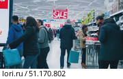 Shoppers browse aisles filled with deals and discounts during a bustling holiday sale event. Стоковое AI-видео, аниматор Данила Большаков / Фотобанк Лори