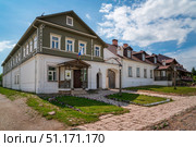 Izborsk, Pskov region, Russia, June 9, 2024: View of historical merchant buildings of estates on the main street of Izborsk Pechorskaya Street on a summer sunny day. Редакционное фото, фотограф Ula Ulachka / Фотобанк Лори