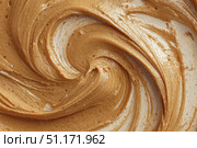 Creamy peanut butter spread swirl surface. Closeup, full frame. Crunchy Peanut butter background. American cuisine traditional product. Appetizing textured smears. Food paste from ground roasted nuts. Стоковое AI-изображение, AI-художник Марина Демидюк / Фотобанк Лори